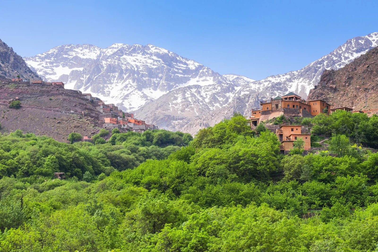A Berber village below the snow-capped peaks of the High Atlas